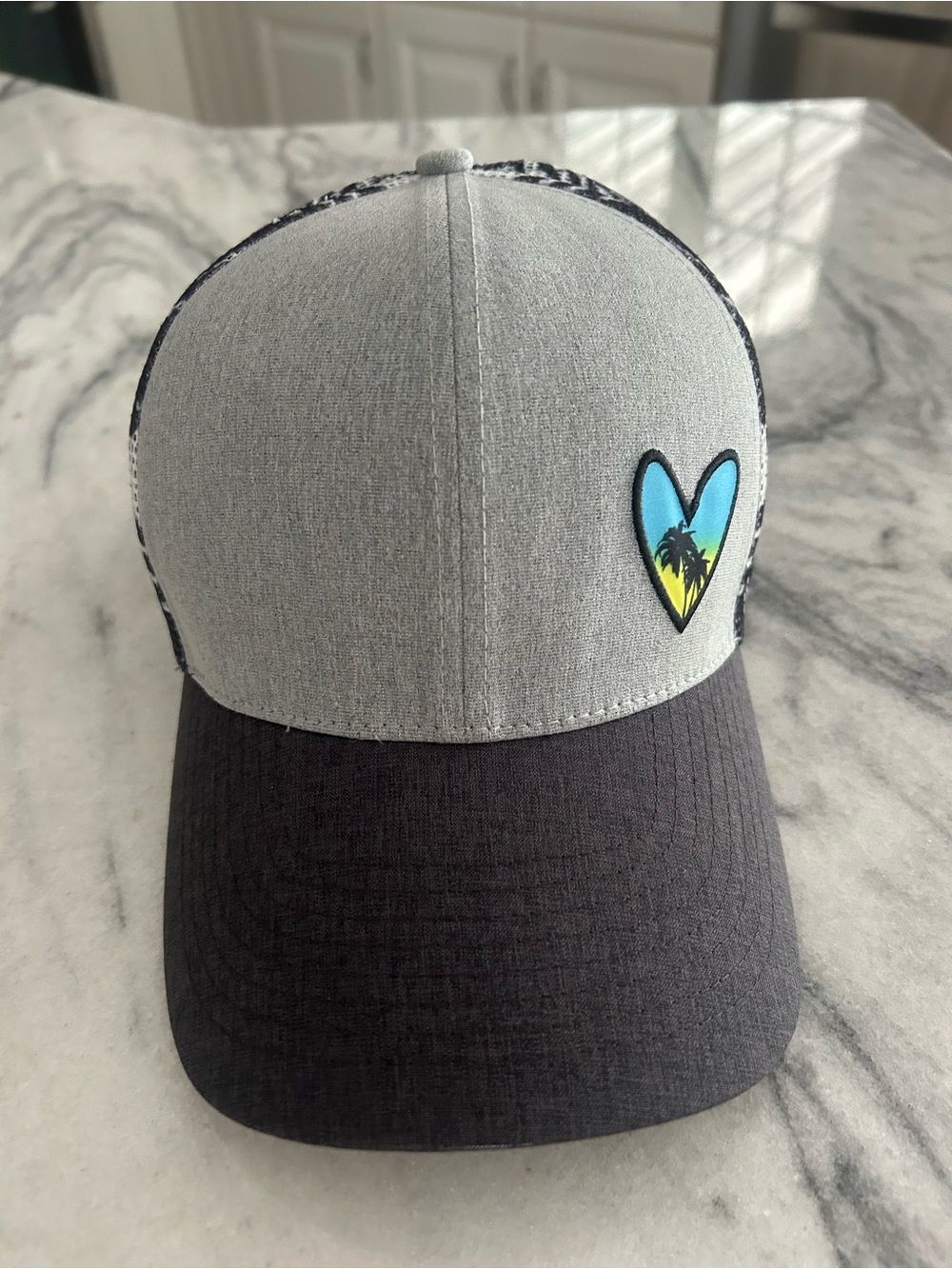 Women’s Two-Tone Grey and Black Trucker Hat with Heart Palm Design